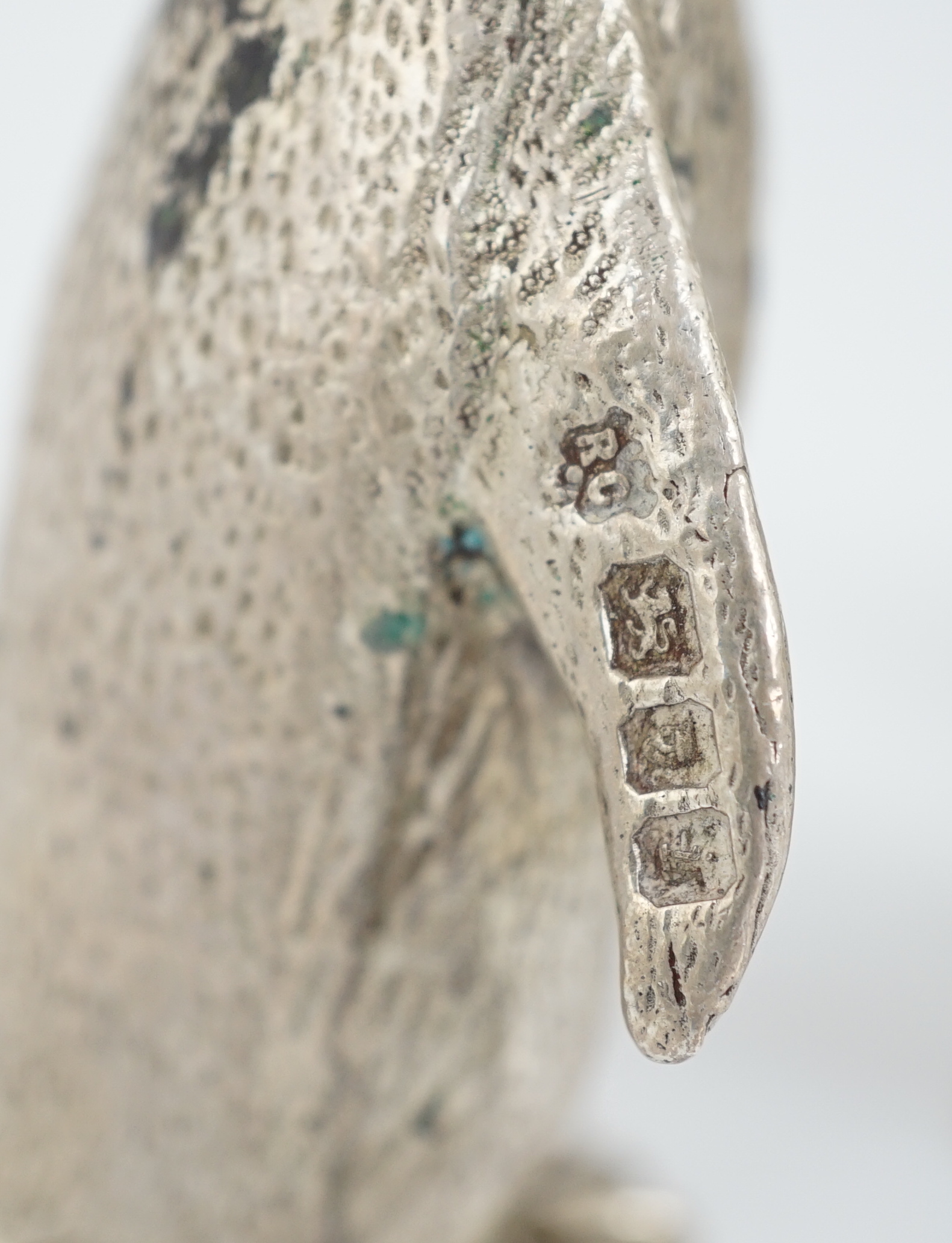 An Elizabeth II graduated suite of three novelty silver condiments, modelled as penguins, by William Comyns & Sons Ltd